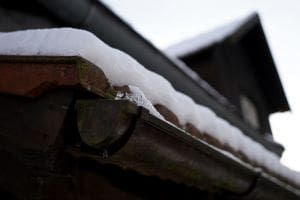 winterize your home to protect from damage from ice and snow on roof and in gutter on house